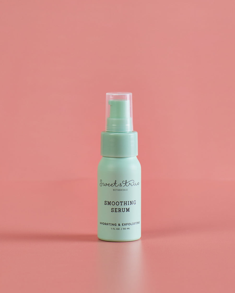 Mint-green Smoothing Serum bottle on a warm pink background